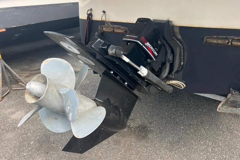 Slide: The Image of 2006 Monterey 270 Cruiser with Mercury MerCruiser outdrive and propeller, parked on pavement. - 3