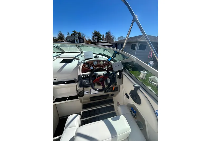 Slide: The Image of 2006 Monterey 270 Cruiser cockpit with steering wheel and navigation equipment under clear blue sky. - 4