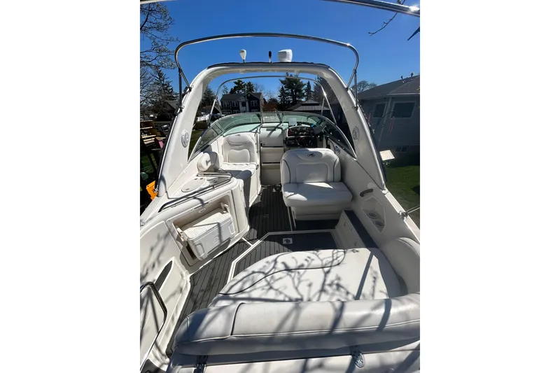 Slide: The Image of 2006 Monterey 270 Cruiser boat interior with white seating and steering console. - 5