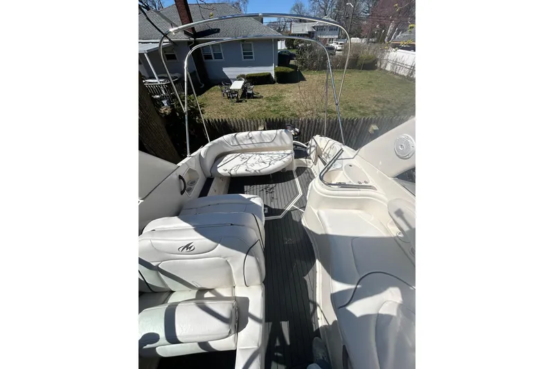 Slide: The Image of 2006 Monterey 270 Cruiser boat interior with white seating and outdoor view. - 8