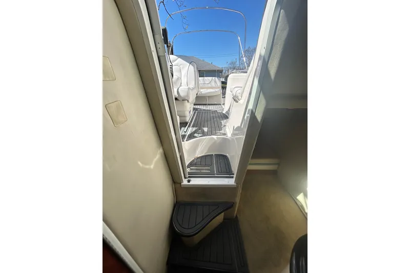 Slide: The Image of Interior view of a 2006 Monterey 270 Cruiser boat, showcasing seating and deck area. - 9