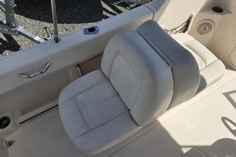 Slide: The Image of 2015 Grady-White Freedom 205 boat interior with cushioned seating and speaker. - 10