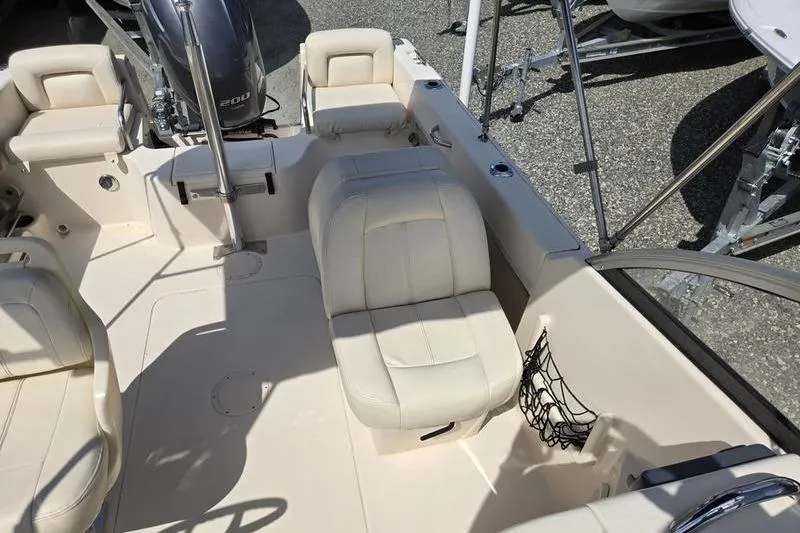 Slide: The Image of 2015 Grady-White Freedom 205 boat interior with beige seating and Yamaha outboard motor. - 14