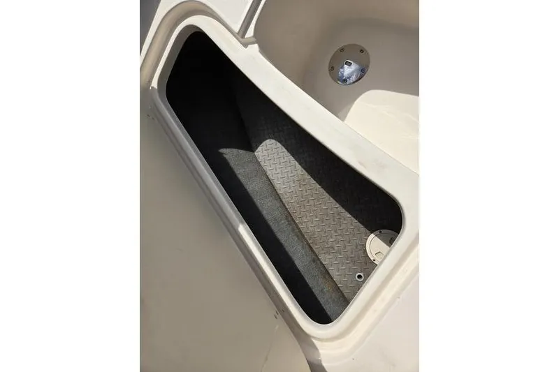 Slide: The Image of Storage compartment of 2015 Grady-White Freedom 205 boat, featuring diamond-patterned flooring. - 19