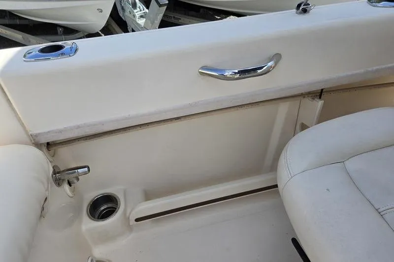 Slide: The Image of Interior view of a 2015 Grady-White Freedom 205 boat, featuring seating and chrome details. - 21