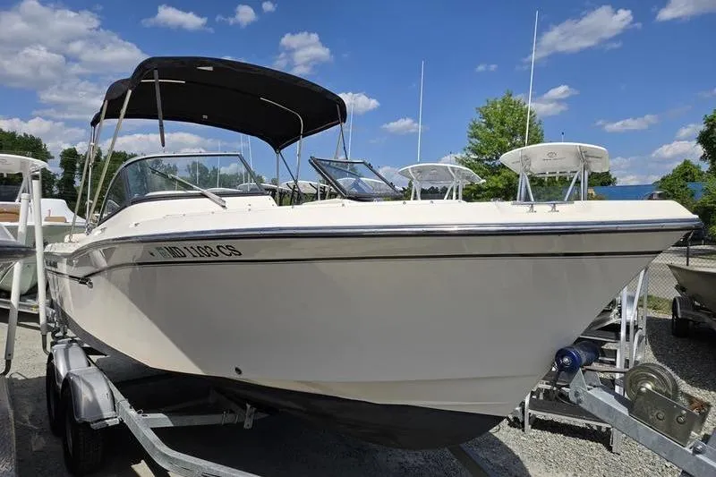 Slide: The Image of 2015 Grady-White Freedom 205 boat on trailer under clear blue sky. - 22