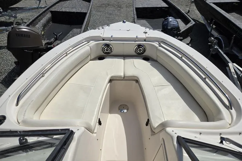 Slide: The Image of 2015 Grady-White Freedom 205 boat interior with cushioned seating and speakers. - 23