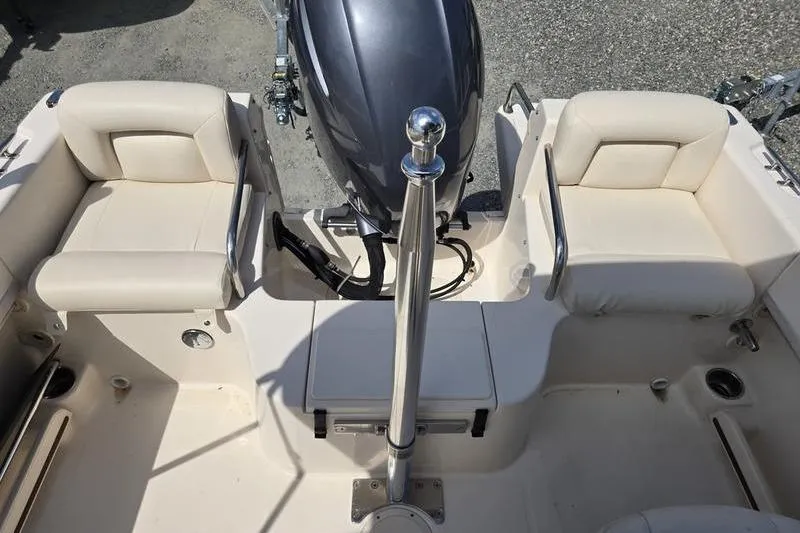 Slide: The Image of 2015 Grady-White Freedom 205 boat interior with seating and motor view. - 26
