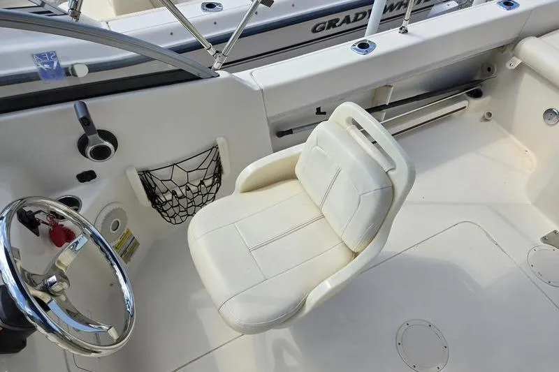 Slide: The Image of 2015 Grady-White Freedom 205 boat interior with steering wheel and cushioned seat. - 3