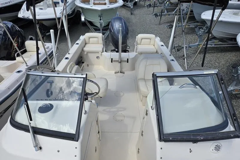 Slide: The Image of 2015 Grady-White Freedom 205 boat interior with seating and steering console. - 8
