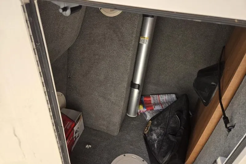 Slide: The Image of Storage compartment of a 2015 Grady-White Freedom 205 boat with various items inside. - 9