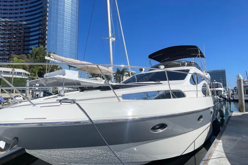 The Image of Luxury 2004 Azimut 46 yacht docked in a modern marina setting. - 0