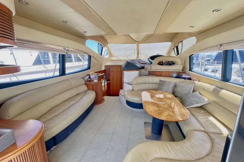 Slide: The Image of Luxurious interior of a 2004 Azimut 46 yacht with elegant seating and wooden accents. - 10