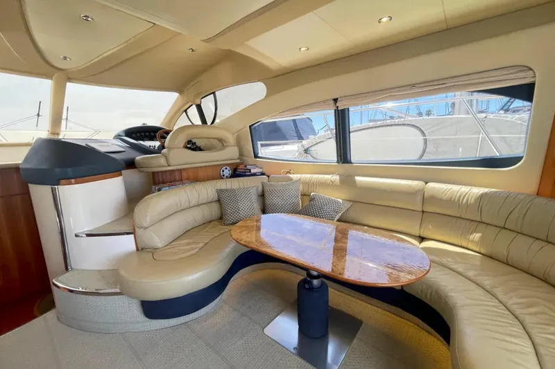 Slide: The Image of Luxurious interior of a 2004 Azimut 46 yacht with plush seating and elegant table. - 12