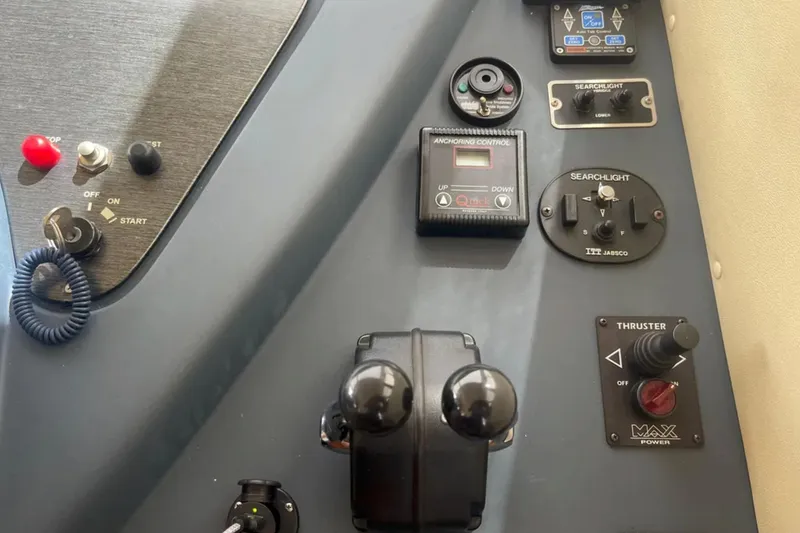 Slide: The Image of Control panel of a 2004 Azimut 46 yacht with various switches and dials. - 14