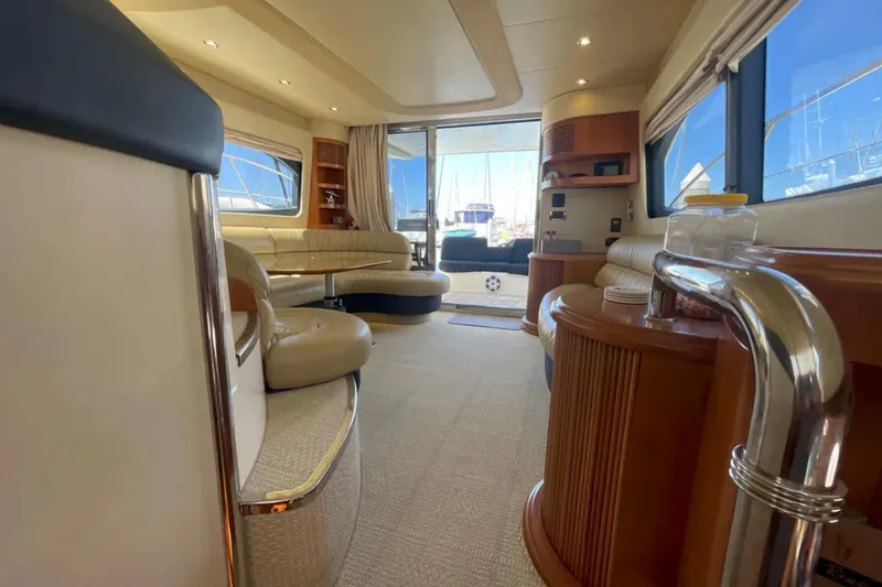 Slide: The Image of Luxurious interior of a 2004 Azimut 46 yacht with elegant seating and panoramic windows. - 15