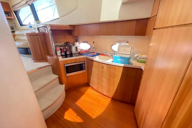 Slide: The Image of Luxurious 2004 Azimut 46 yacht interior with modern kitchen and wooden cabinetry. - 16