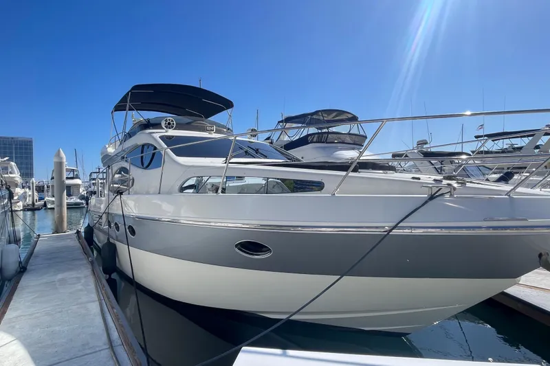 Slide: The Image of 2004 Azimut 46 yacht docked at marina under clear blue sky. - 2