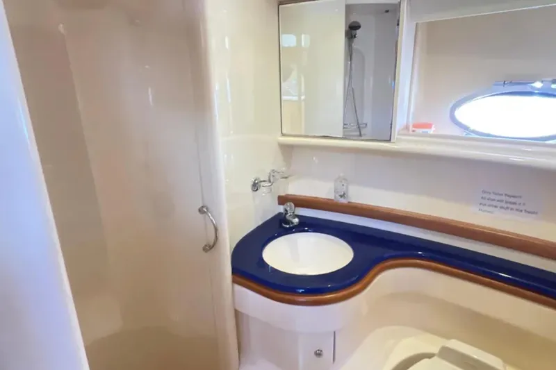 Slide: The Image of Bathroom interior of 2004 Azimut 46 yacht, featuring a sleek sink and shower area. - 20