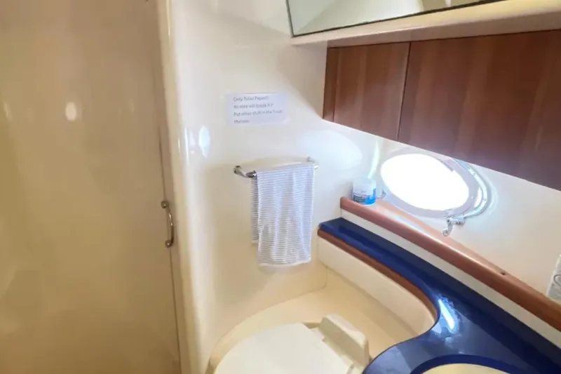 Slide: The Image of Bathroom interior of 2004 Azimut 46 yacht with porthole and wooden cabinets. - 22