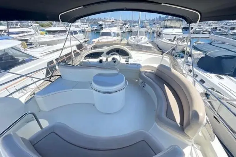 Slide: The Image of 2004 Azimut 46 yacht interior with seating area, docked in a marina. - 24