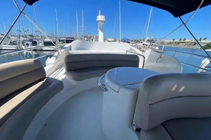 Slide: The Image of 2004 Azimut 46 yacht with spacious seating area in a marina setting. - 28