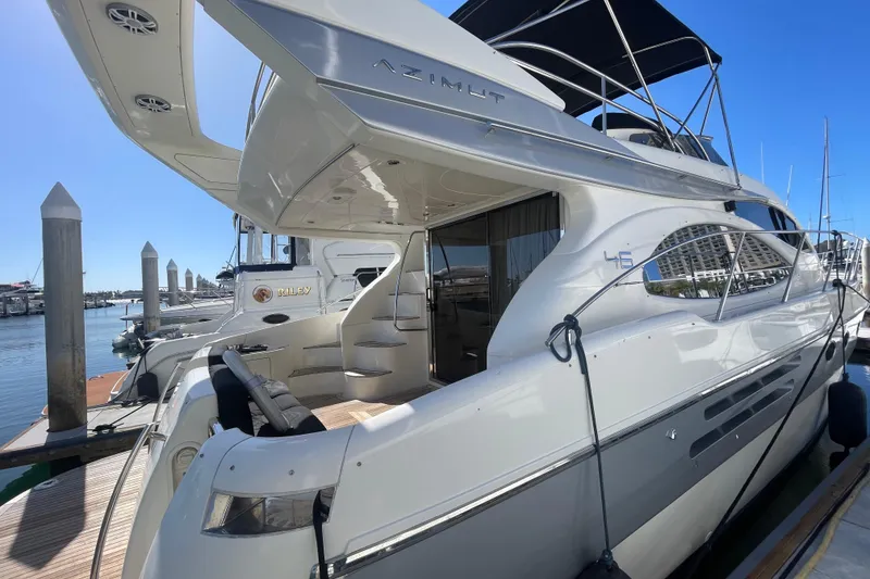 Slide: The Image of 2004 Azimut 46 yacht docked at marina, showcasing sleek design and luxurious features. - 3