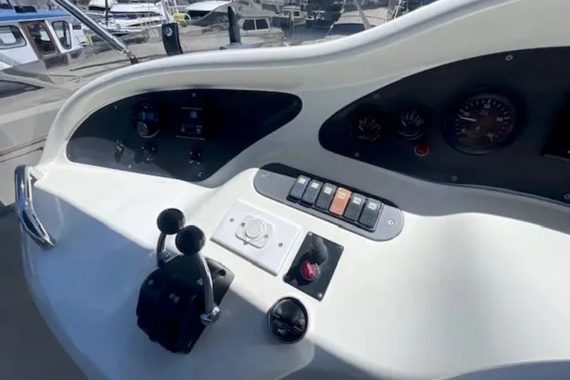 Slide: The Image of Control panel of a 2004 Azimut 46 yacht, featuring gauges and switches. - 32