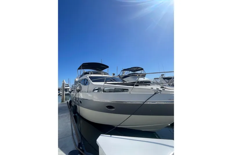 Slide: The Image of 2004 Azimut 46 yacht docked under clear blue sky. - 4