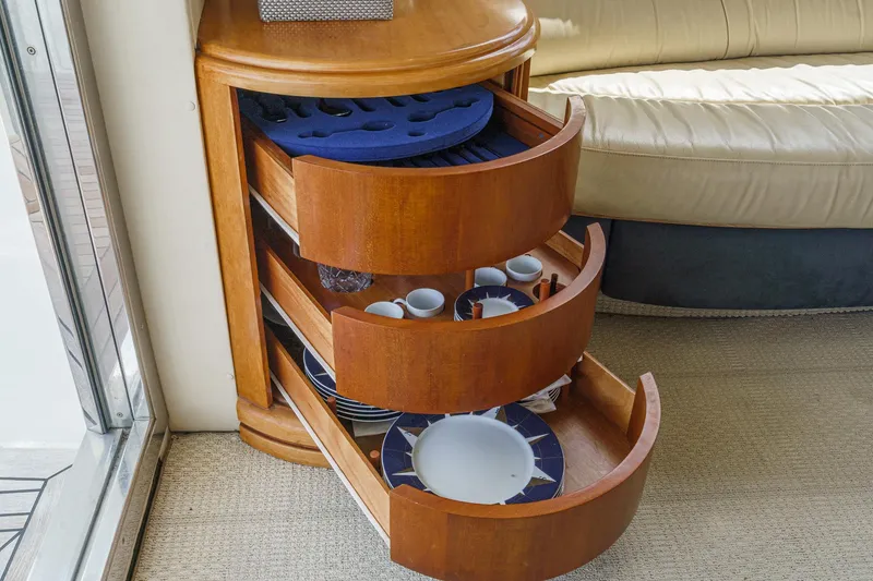 Slide: The Image of Luxury yacht Azimut 46 (2004) interior with elegant wooden drawers and tableware. - 44