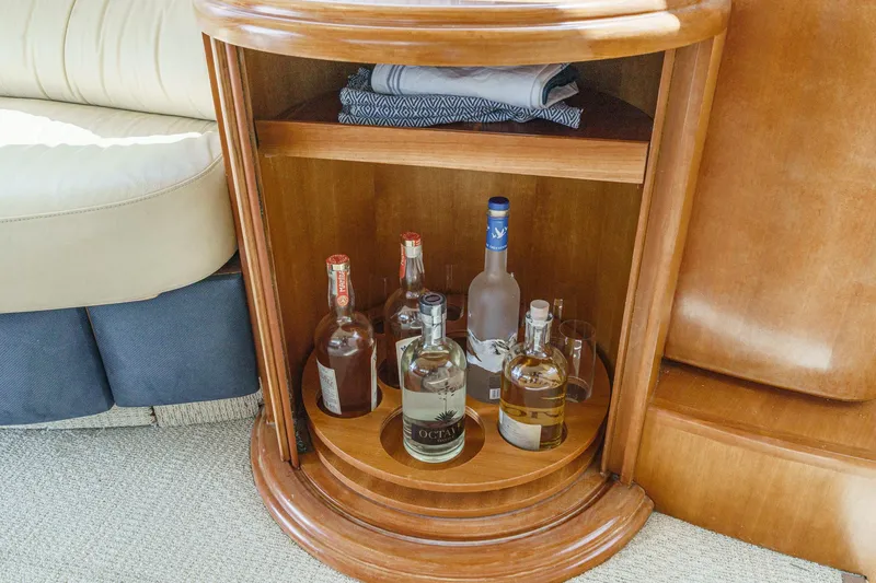 Slide: The Image of Luxury yacht Azimut 46 interior with wooden cabinet and assorted liquor bottles, 2004 model. - 45