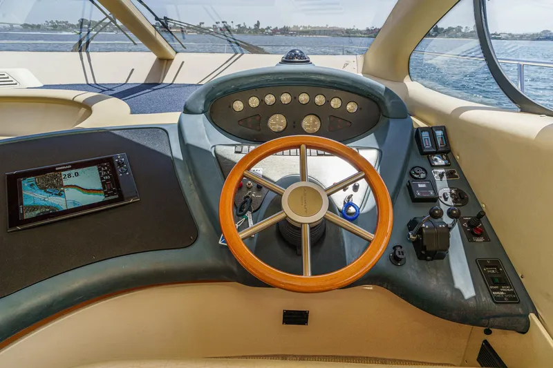 Slide: The Image of Cockpit of 2004 Azimut 46 yacht with wooden steering wheel and navigation controls. - 48