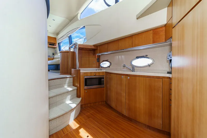 Slide: The Image of Luxurious interior of 2004 Azimut 46 yacht featuring modern kitchen and elegant wood finishes. - 54