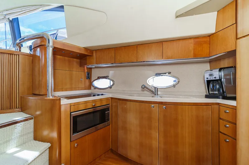 Slide: The Image of Luxurious 2004 Azimut 46 yacht kitchen with wood cabinetry, microwave, and coffee maker. - 55