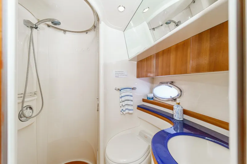 Slide: The Image of Luxurious bathroom in 2004 Azimut 46 yacht with shower, sink, and wooden cabinetry. - 62