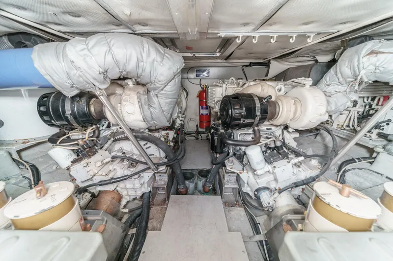 Slide: The Image of Engine room of a 2004 Azimut 46 yacht, featuring dual engines and fire extinguisher. - 67