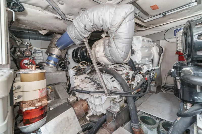 Slide: The Image of Engine room of a 2004 Azimut 46 yacht, showcasing mechanical components and systems. - 69