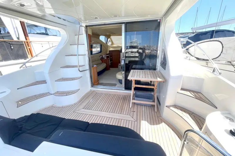 Slide: The Image of Luxurious 2004 Azimut 46 yacht interior with elegant seating and wooden flooring. - 7
