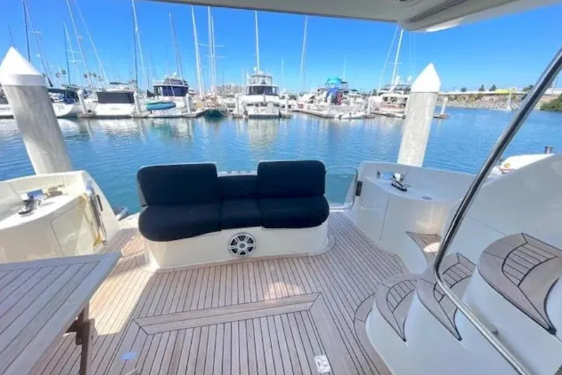 Slide: The Image of Luxurious 2004 Azimut 46 yacht deck with seating, overlooking marina and boats. - 8