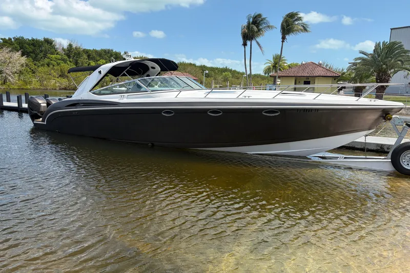 The Image of 1999 Formula 400 Super Sport boat docked in a scenic marina setting. - 0