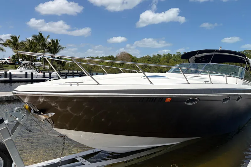 Slide: The Image of 1999 Formula 400 Super Sport boat docked under a clear blue sky. - 2