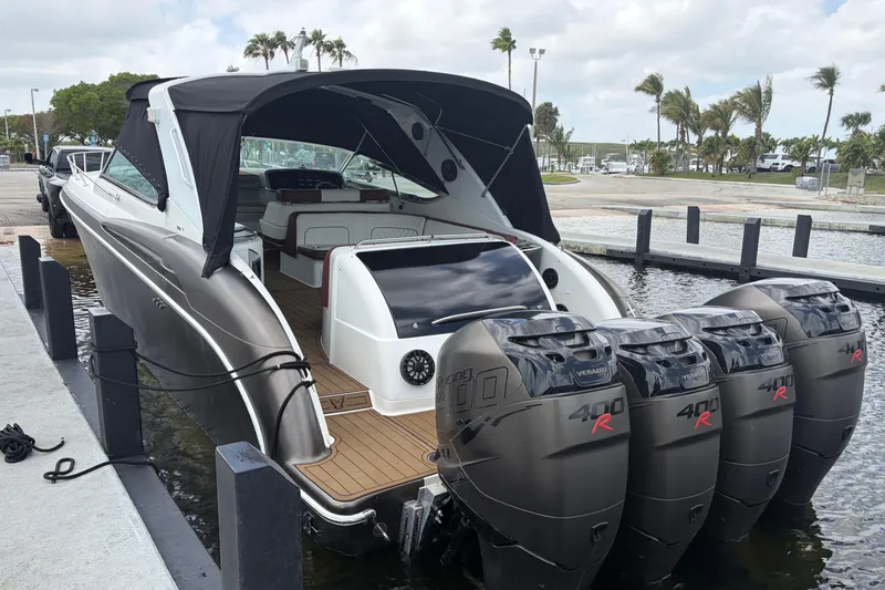 Slide: The Image of 1999 Formula 400 Super Sport boat docked with four powerful outboard engines. - 3