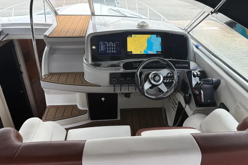 Slide: The Image of Cockpit of a 1999 Formula 400 Super Sport boat with navigation screens and steering wheel. - 5