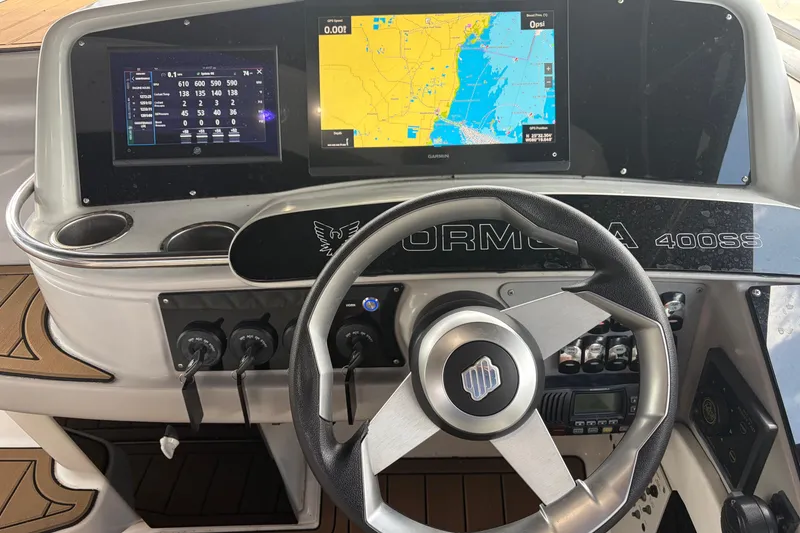 Slide: The Image of 1999 Formula 400 Super Sport dashboard with navigation screens and steering wheel. - 6