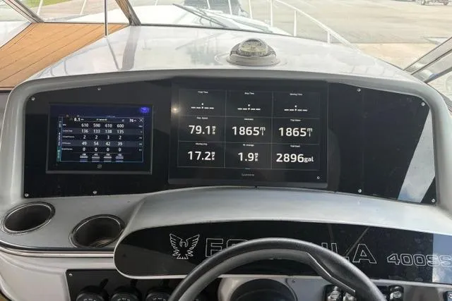 Slide: The Image of Dashboard of a 1999 Formula 400 Super Sport boat with digital displays and controls. - 7