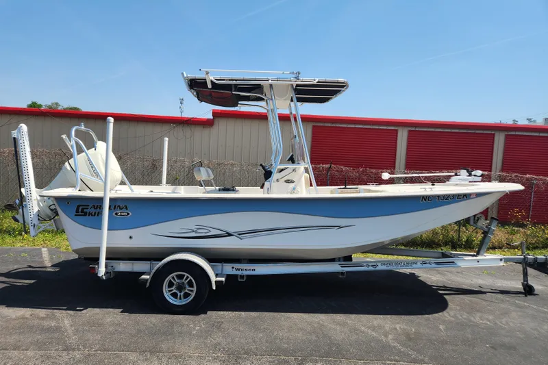 The Image of 2019 Carolina Skiff 218 DLV boat on trailer, parked outdoors. - 0