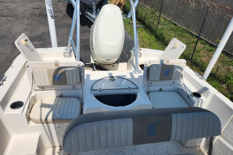 Slide: The Image of 2019 Carolina Skiff 218 DLV boat interior with seating and storage compartments. - 11