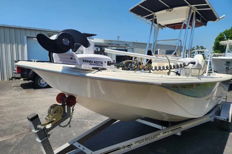 Slide: The Image of 2019 Carolina Skiff 218 DLV boat with Minn Kota PowerDrive, parked on a trailer. - 2