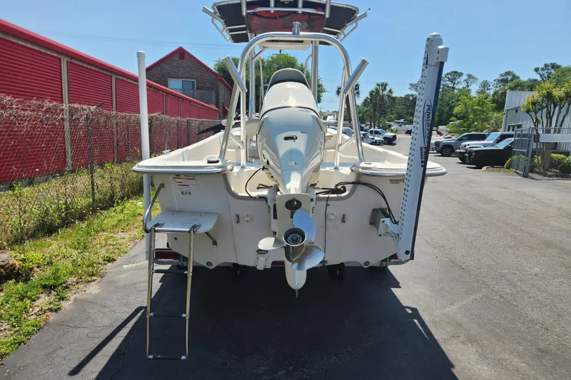 Slide: The Image of 2019 Carolina Skiff 218 DLV boat rear view with motor and ladder. - 4