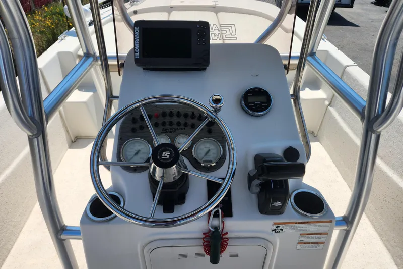 Slide: The Image of 2019 Carolina Skiff 218 DLV boat console with steering wheel and navigation equipment. - 5